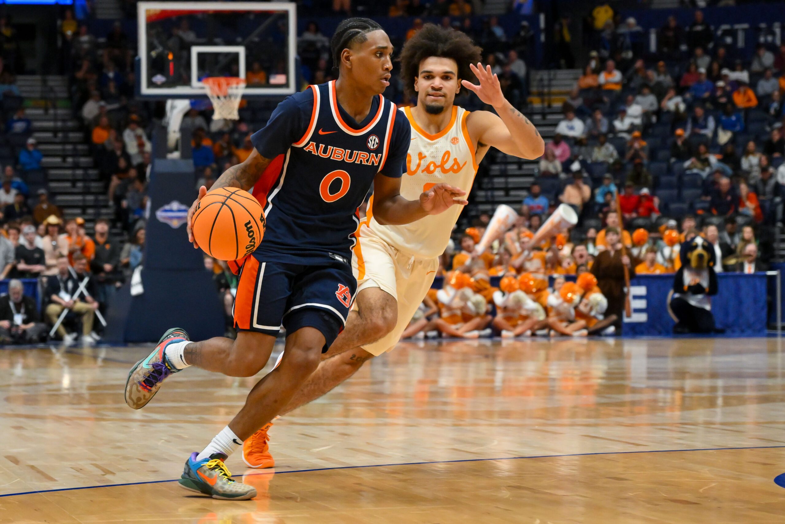 Mar 12, 2026; Nashville, TN, USA;  Auburn Tigers guard Tahaad Pettiford (0) drives to the basket past Tennessee Volunteers guard Bishop Boswell (3) during the second half at Bridgestone Arena. Mandatory Credit: Steve Roberts-Imagn Images