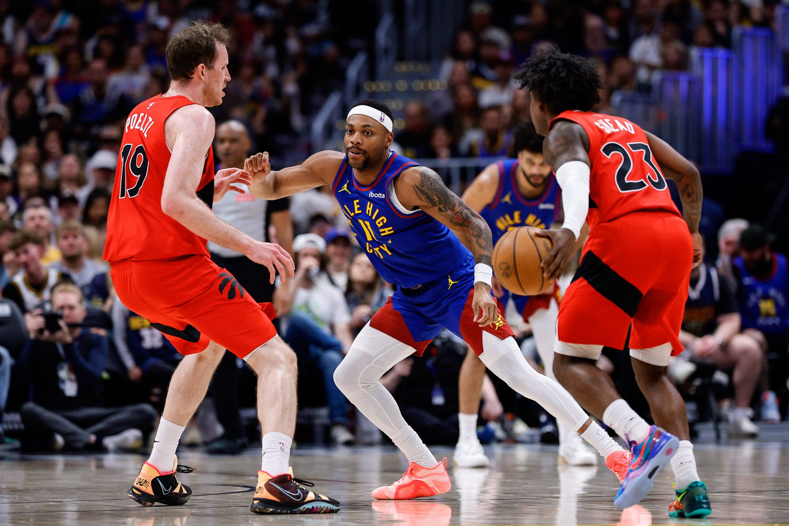 Mar 20, 2026; Denver, Colorado, USA; Toronto Raptors guard Jamal Shead (23) controls the ball as Denver Nuggets guard Bruce Brown (11) and center Jakob Poeltl (19) battle for position in the third quarter at Ball Arena. Mandatory Credit: Isaiah J. Downing-Imagn Images