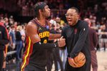 Mar 21, 2026; Atlanta, Georgia, USA; Atlanta Hawks guard Buddy Hield (8) celebrates with attendant Xavier McKenzie after a victory over the Golden State Warriors at State Farm Arena. Mandatory Credit: Brett Davis-Imagn Images