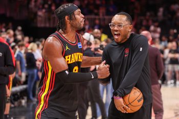 Mar 21, 2026; Atlanta, Georgia, USA; Atlanta Hawks guard Buddy Hield (8) celebrates with attendant Xavier McKenzie after a victory over the Golden State Warriors at State Farm Arena. Mandatory Credit: Brett Davis-Imagn Images