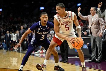 Mar 21, 2026; Portland, OR, USA; Arkansas Razorbacks guard Darius Acuff Jr. (5) drives against High Point Panthers guard Rob Martin (3) in the second half during a second round game of the men's 2026 NCAA Tournament at Moda Center. Mandatory Credit: Troy Wayrynen-Imagn Images