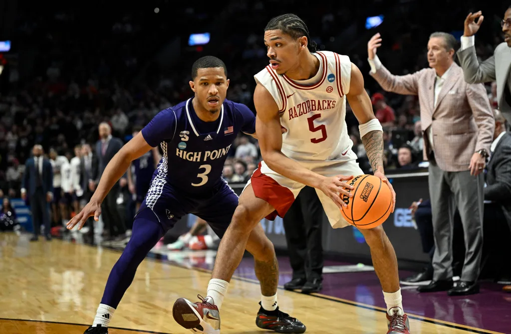Mar 21, 2026; Portland, OR, USA; Arkansas Razorbacks guard Darius Acuff Jr. (5) drives against High Point Panthers guard Rob Martin (3) in the second half during a second round game of the men's 2026 NCAA Tournament at Moda Center. Mandatory Credit: Troy Wayrynen-Imagn Images