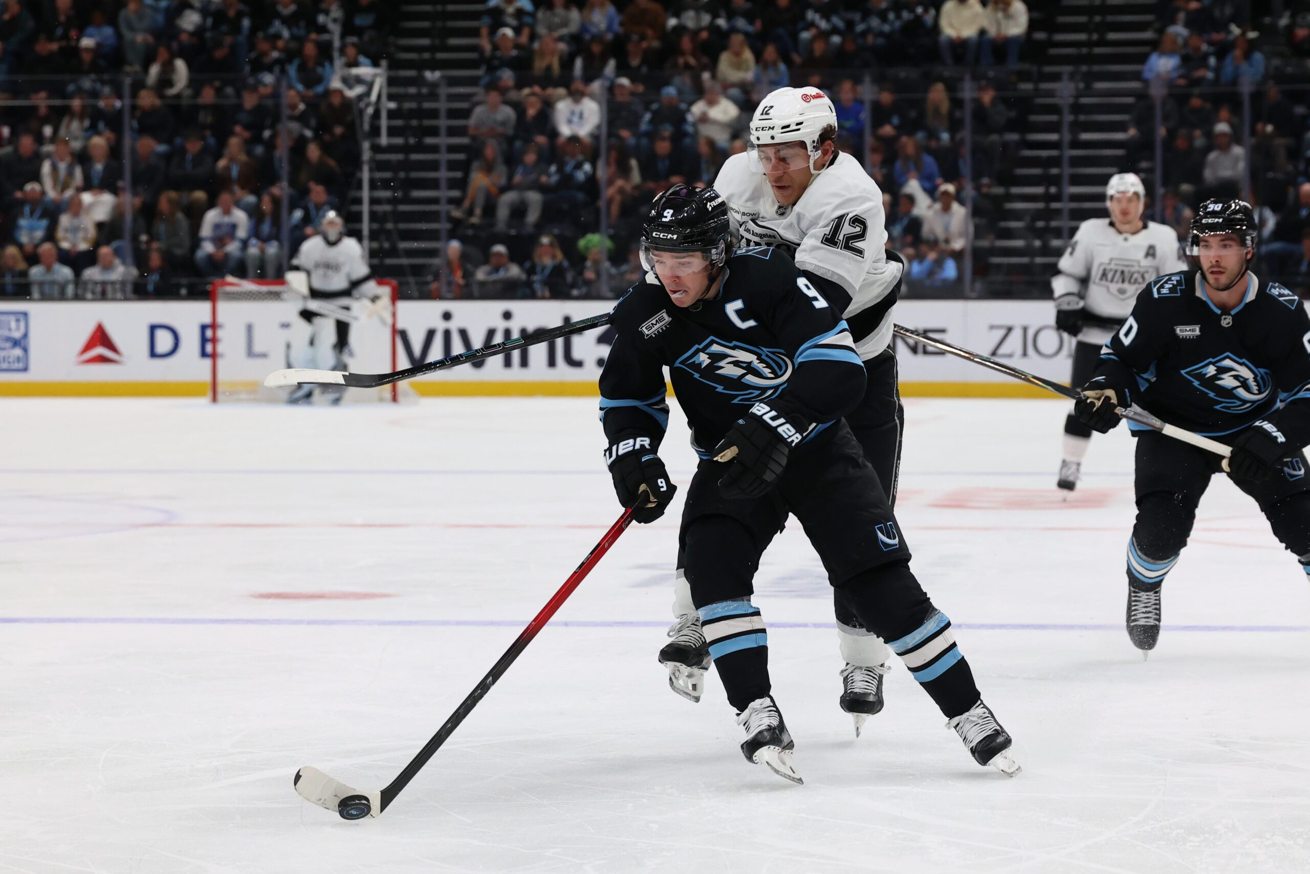 Mar 22, 2026; Salt Lake City, Utah, USA; Utah Mammoth right wing Clayton Keller (9) skates with the puck against Los Angeles Kings left wing Trevor Moore (12) during the third period at Delta Center. Mandatory Credit: Rob Gray-Imagn Images