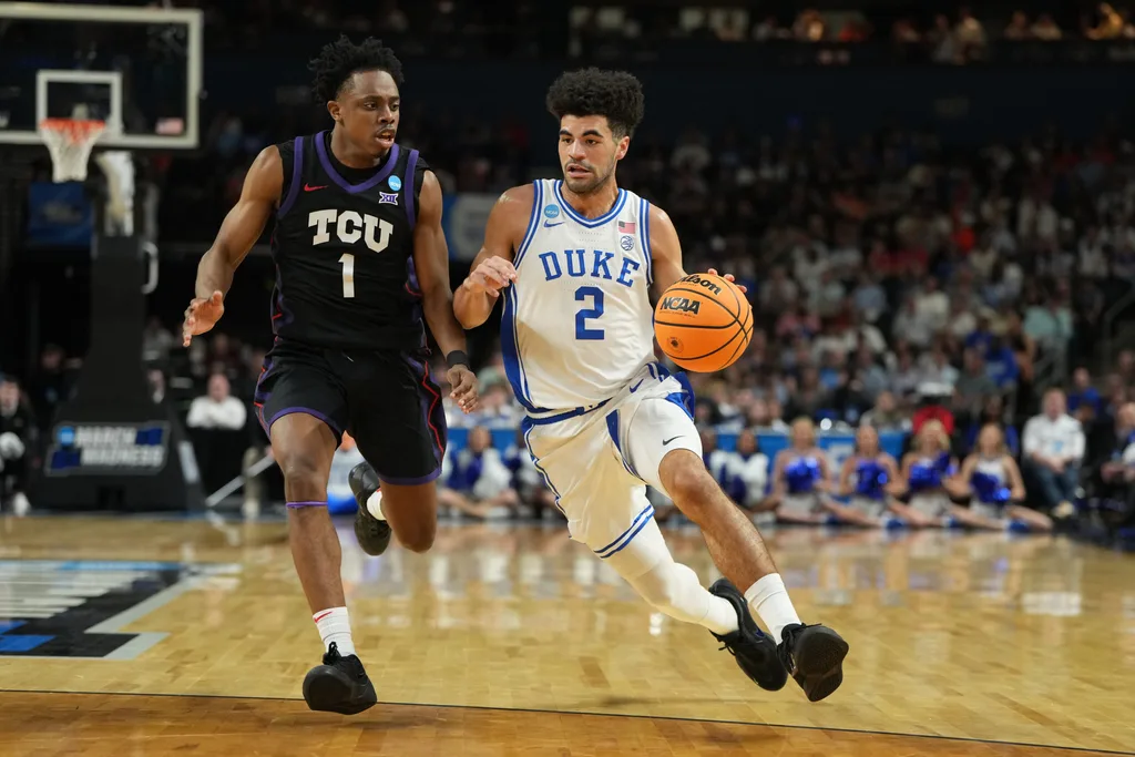 Mar 21, 2026; Greenville, SC, USA; Duke Blue Devils guard Cayden Boozer (2) with the ball as Texas Christian University Horned Frogs guard Jayden Pierre (1) defends in the first half during a second round game of the men's 2026 NCAA Tournament at Bon Secours Wellness Arena. Mandatory Credit: Bob Donnan-Imagn Images