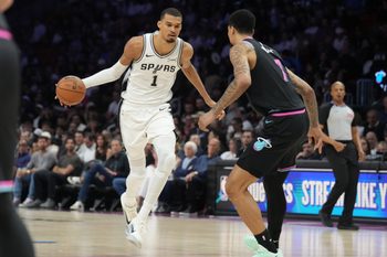 Mar 23, 2026; Miami, Florida, USA;  San Antonio Spurs forward Victor Wembanyama (1) drives to the basket as Miami Heat center Kel'el Ware (7) defends during the second half at Kaseya Center. Mandatory Credit: Jim Rassol-Imagn Images