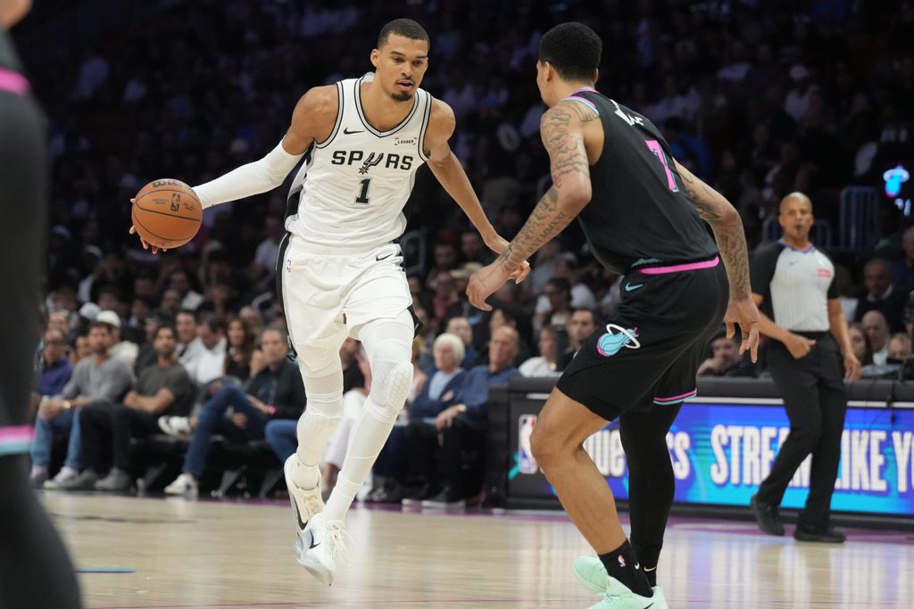 Mar 23, 2026; Miami, Florida, USA; San Antonio Spurs forward Victor Wembanyama (1) drives to the basket as Miami Heat center Kel'el Ware (7) defends during the second half at Kaseya Center. Mandatory Credit: Jim Rassol-Imagn Images