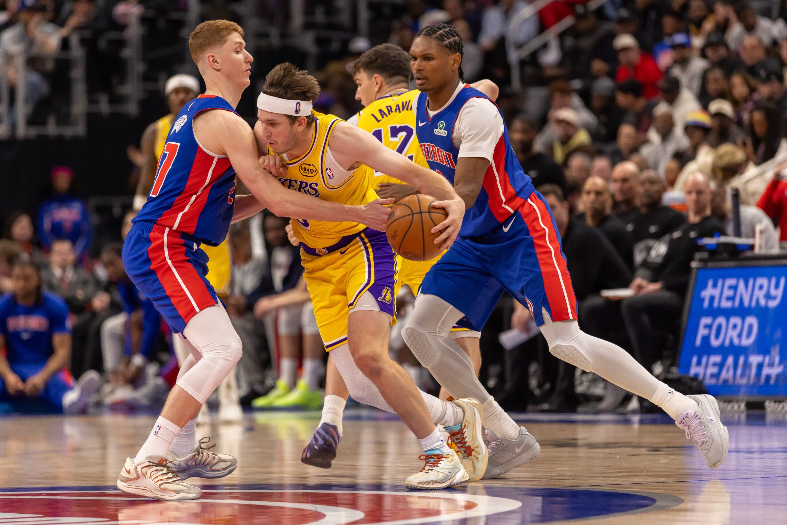 Mar 23, 2026; Detroit, Michigan, USA; Detroit Pistons Kevin Huerter (27) defends against Los Angeles Lakers Austin Reaves (15) during the second half at Little Caesars Arena. Mandatory Credit: David Reginek-Imagn Images