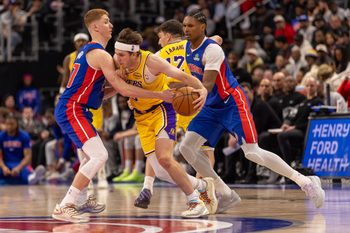 Mar 23, 2026; Detroit, Michigan, USA; Detroit Pistons Kevin Huerter (27) defends against Los Angeles Lakers Austin Reaves (15) during the second half at Little Caesars Arena. Mandatory Credit: David Reginek-Imagn Images