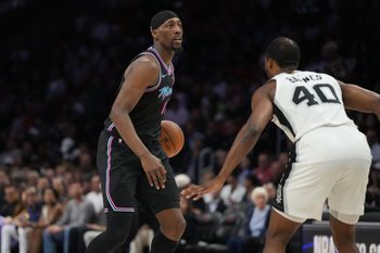 Mar 23, 2026; Miami, Florida, USA;  Miami Heat center Bam Adebayo (13) looks to pass the ball as San Antonio Spurs forward Harrison Barnes (40) defends during the first half at Kaseya Center. Mandatory Credit: Jim Rassol-Imagn Images