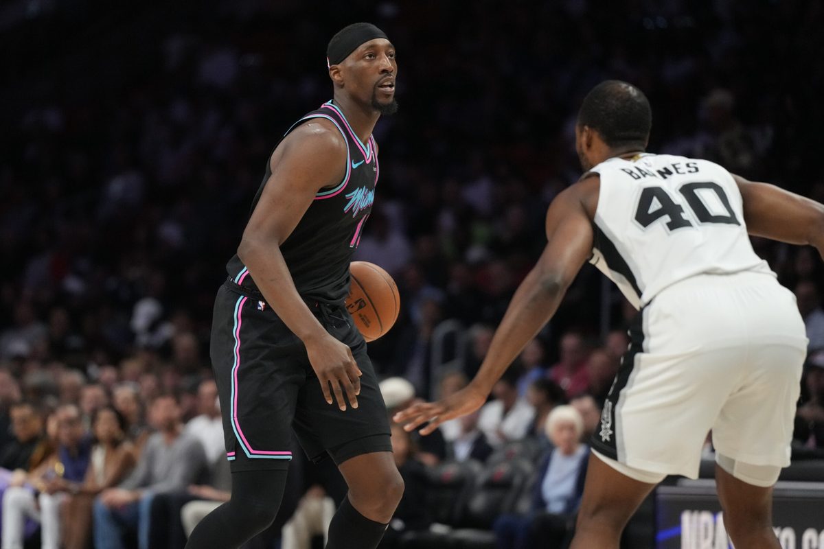 Mar 23, 2026; Miami, Florida, USA; Miami Heat center Bam Adebayo (13) looks to pass the ball as San Antonio Spurs forward Harrison Barnes (40) defends during the first half at Kaseya Center. Mandatory Credit: Jim Rassol-Imagn Images