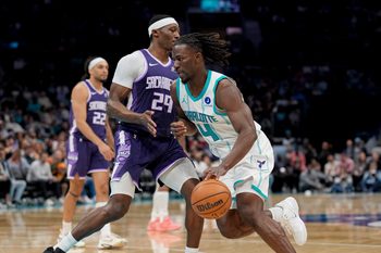 Mar 24, 2026; Charlotte, North Carolina, USA; Charlotte Hornets guard Sion James (4) moves the ball against Sacramento Kings guard/forward Daeqwon Plowden (29) during the second half at Spectrum Center. Mandatory Credit: Jim Dedmon-Imagn Images