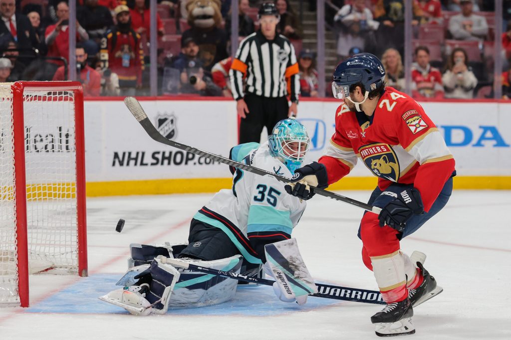 Mar 24, 2026; Sunrise, Florida, USA; Florida Panthers center Vinnie Hinostroza (24) scores the winning goal against Seattle Kraken goaltender Joey Daccord (35) during a shootout at Amerant Bank Arena. Mandatory Credit: Sam Navarro-Imagn Images