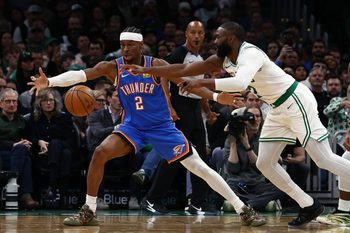 Mar 25, 2026; Boston, Massachusetts, USA; Oklahoma City Thunder guard Shai Gilgeous-Alexander (2) and Boston Celtics guard Jaylen Brown (7) eye a loose ball during the second quarter at TD Garden. Mandatory Credit: Winslow Townson-Imagn Images