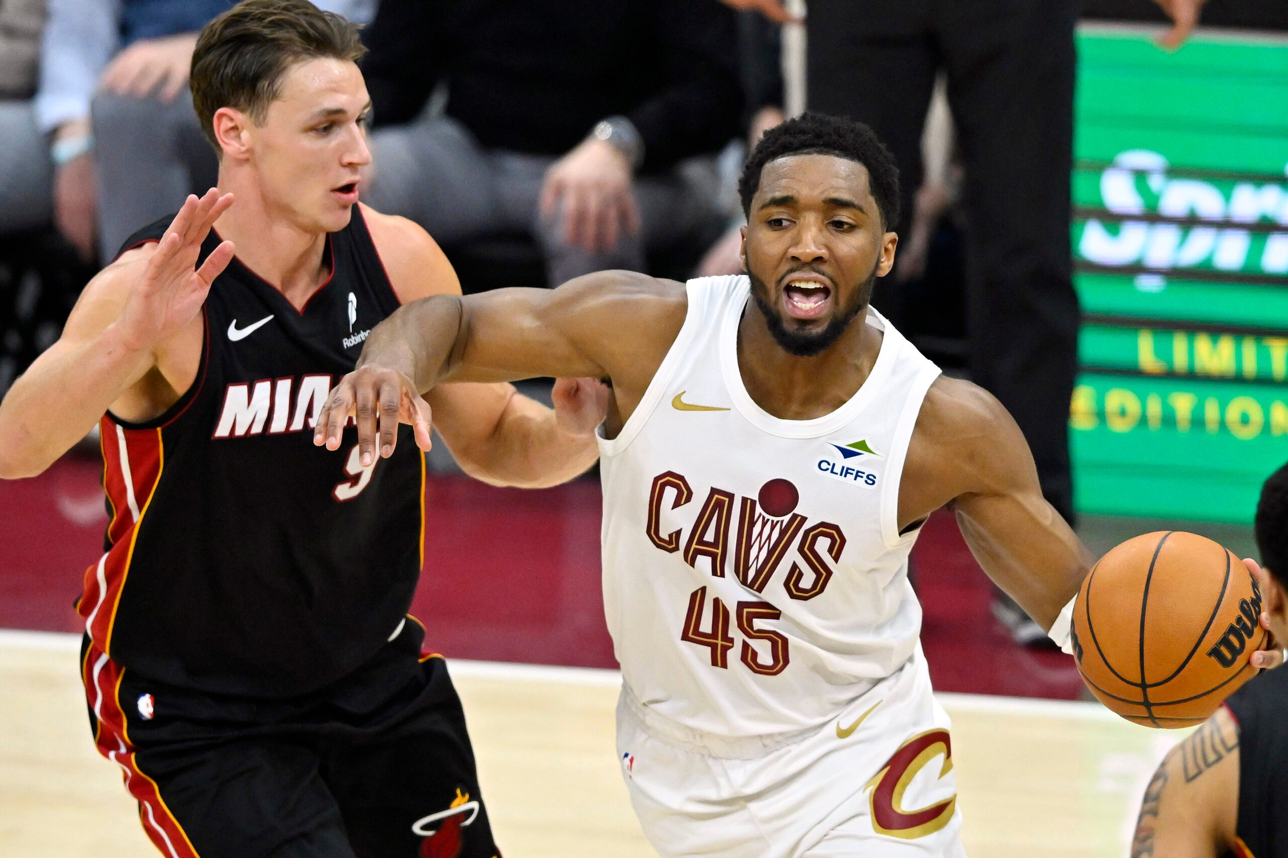 Mar 25, 2026; Cleveland, Ohio, USA; Miami Heat guard Pelle Larsson (9) defends Cleveland Cavaliers guard Donovan Mitchell (45) in the fourth quarter at Rocket Arena. Mandatory Credit: David Richard-Imagn Images