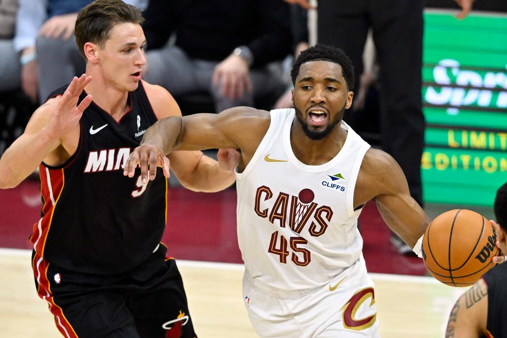 Mar 25, 2026; Cleveland, Ohio, USA; Miami Heat guard Pelle Larsson (9) defends Cleveland Cavaliers guard Donovan Mitchell (45) in the fourth quarter at Rocket Arena. Mandatory Credit: David Richard-Imagn Images