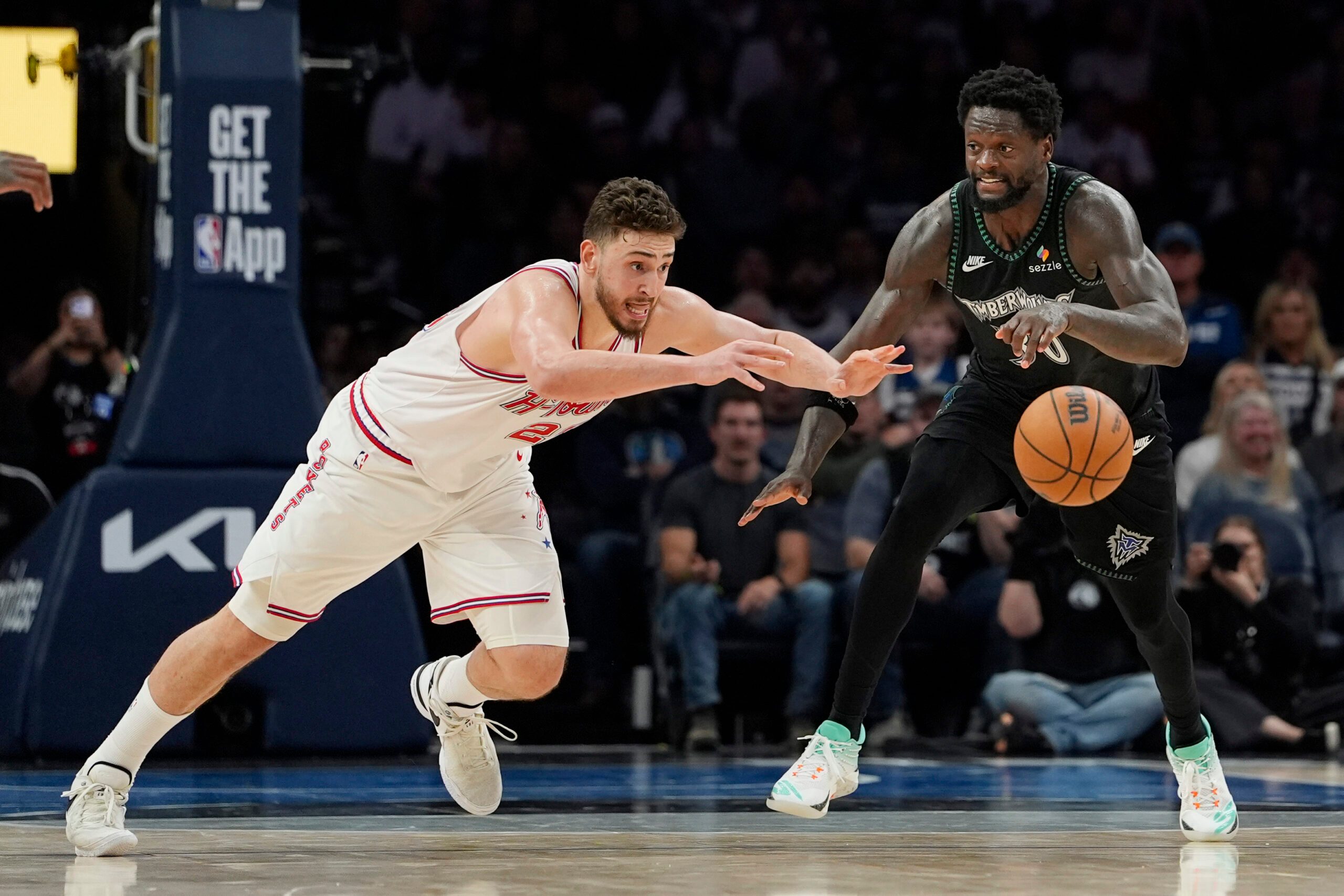 Mar 25, 2026; Minneapolis, Minnesota, USA; Houston Rockets center Alperen Sengun (28) challenges Minnesota Timberwolves forward Julius Randle (30) for the ball in the fourth quarter at Target Center. Mandatory Credit: Bruce Kluckhohn-Imagn Images