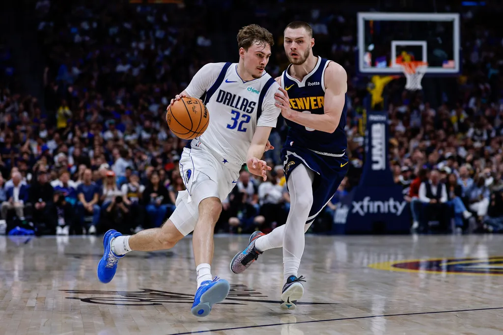Mar 25, 2026; Denver, Colorado, USA; Dallas Mavericks forward Cooper Flagg (32) controls the ball as Denver Nuggets guard Christian Braun (0) guards in the third quarter at Ball Arena. Mandatory Credit: Isaiah J. Downing-Imagn Images