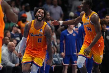 Mar 26, 2026; Charlotte, North Carolina, USA;  Charlotte Hornets forward Miles Bridges (0) and forward Moussa Diabaté (14) react after a score against the New York Knicks during the second half at the Spectrum Center. Mandatory Credit: Jim Dedmon-Imagn Images
