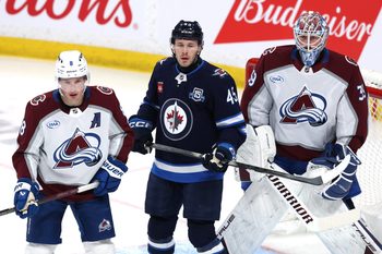Mar 26, 2026; Winnipeg, Manitoba, CAN; Colorado Avalanche defenseman Cale Makar (8), Winnipeg Jets left wing Cole Koepke (45) and Colorado Avalanche goaltender MacKenzie Blackwood (39) watch a developing play in the third period at Canada Life Centre. Mandatory Credit: James Carey Lauder-Imagn Images
