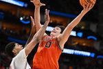 Mar 26, 2026; Houston, TX, USA; Illinois Fighting Illini forward David Mirkovic (0) shoots the ball against Houston Cougars center Chris Cenac Jr. (5) in the second half during a Sweet Sixteen game of the South Regional of the men's 2026 NCAA Tournament at Toyota Center. Mandatory Credit: Maria Lysaker-Imagn Images