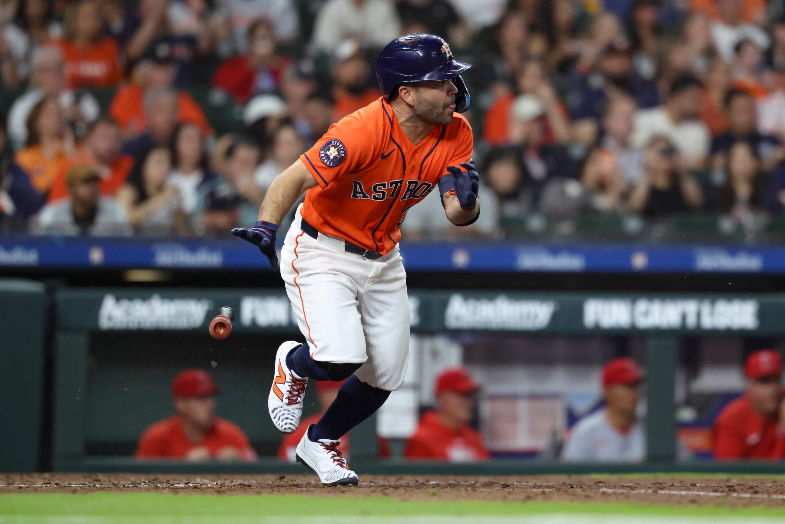 Mar 27, 2026; Houston, Texas, USA; Houston Astros second baseman Jose Altuve (27) hits an infield single during the fifth inning against the Los Angeles Angels at Daikin Park. Mandatory Credit: Troy Taormina-Imagn Images