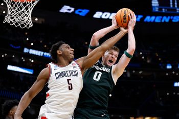 Mar 27, 2026; Washington, DC, USA; Michigan State Spartans forward Jaxon Kohler (0) grabs a rebound on UConn Huskies forward Tarris Reed Jr. (5) in the second half during a Sweet Sixteen game of the East Regional of the men's 2026 NCAA Tournament at Capital One Arena. Mandatory Credit: Amber Searls-Imagn Images
