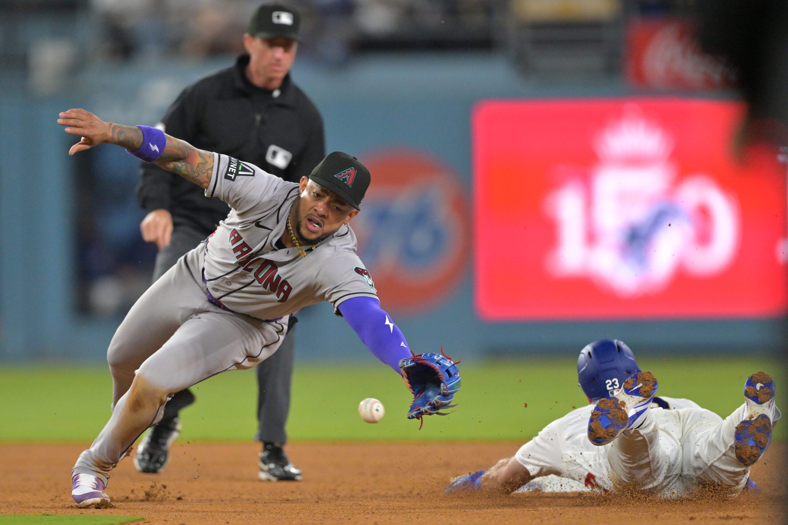 Mar 27, 2026; Los Angeles, California, USA; Los Angeles Dodgers right fielder Kyle Tucker (23) is safe stealing second base against Arizona Diamondbacks shortstop Geraldo Perdomo (2) in the eighth inning at Dodger Stadium. Mandatory Credit: Jayne Kamin-Oncea-Imagn Images