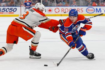 Mar 28, 2026; Edmonton, Alberta, CAN; Edmonton Oilersforward Matt Savoie (22) carries the puck around Anaheim Ducks defensemen Ian Moore (3) during the first period at Rogers Place. Mandatory Credit: Perry Nelson-Imagn Images