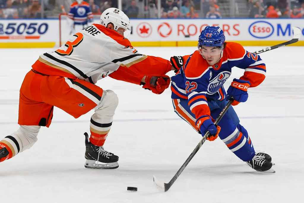 Mar 28, 2026; Edmonton, Alberta, CAN; Edmonton Oilersforward Matt Savoie (22) carries the puck around Anaheim Ducks defensemen Ian Moore (3) during the first period at Rogers Place. Mandatory Credit: Perry Nelson-Imagn Images