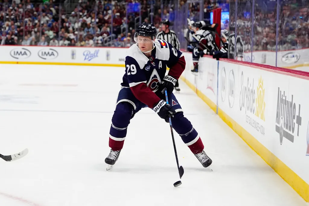 Mar 28, 2026; Denver, Colorado, USA; Colorado Avalanche center Nathan MacKinnon (29) controls the puck in the second period against the Winnipeg Jets at Ball Arena. Mandatory Credit: Ron Chenoy-Imagn Images