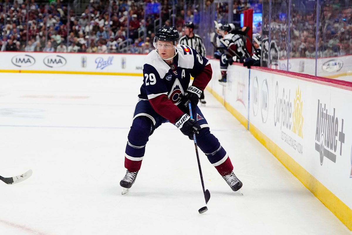 Mar 28, 2026; Denver, Colorado, USA; Colorado Avalanche center Nathan MacKinnon (29) controls the puck in the second period against the Winnipeg Jets at Ball Arena. Mandatory Credit: Ron Chenoy-Imagn Images