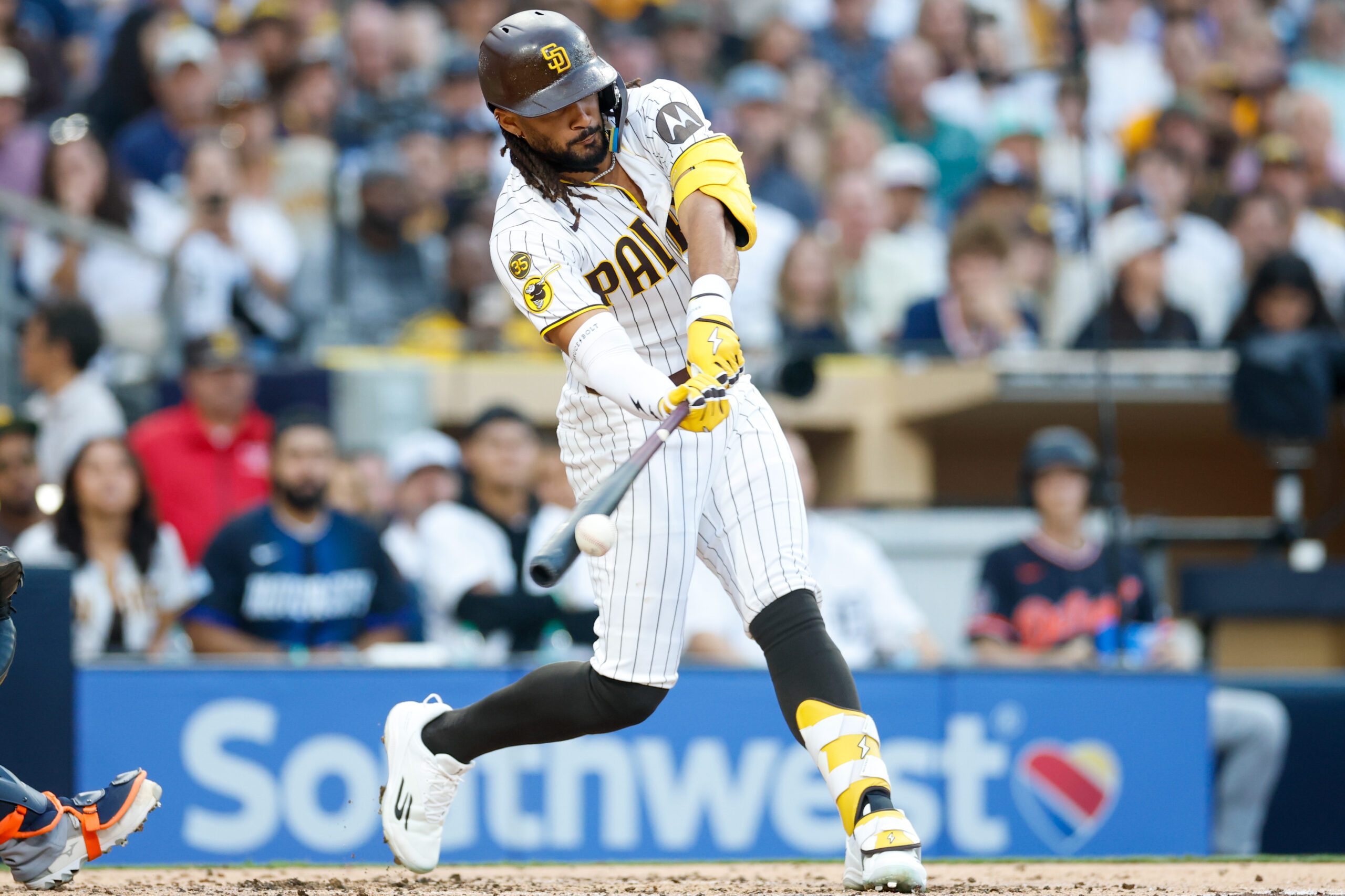 Mar 28, 2026; San Diego, California, USA; San Diego Padres right fielder Fernando Tatis Jr. (23) hits an RBI single during the third inning against the Detroit Tigers at Petco Park. Mandatory Credit: David Frerker-Imagn Images