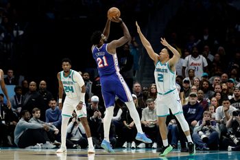 Mar 28, 2026; Charlotte, North Carolina, USA; Philadelphia 76ers center/forward Joel Embiid (21) shoots over Charlotte Hornets forward Grant Williams (2) during the fourth quarter at Spectrum Center. Mandatory Credit: Brian Westerholt-Imagn Images