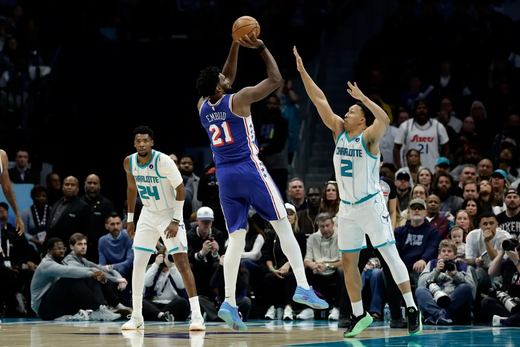 Mar 28, 2026; Charlotte, North Carolina, USA; Philadelphia 76ers center/forward Joel Embiid (21) shoots over Charlotte Hornets forward Grant Williams (2) during the fourth quarter at Spectrum Center. Mandatory Credit: Brian Westerholt-Imagn Images