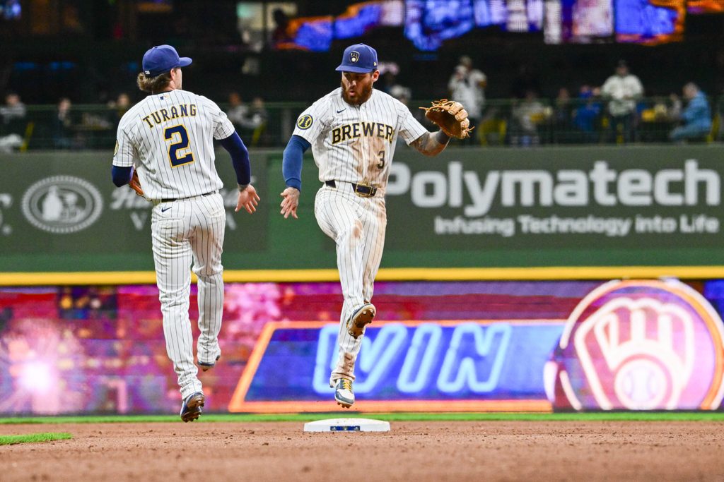 Mar 28, 2026; Milwaukee, Wisconsin, USA; Milwaukee Brewers shortstop Joey Ortiz (3) and second baseman Brice Turang (2) celebrate after beating the Chicago White Sox at American Family Field. Mandatory Credit: Benny Sieu-Imagn Images