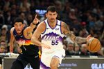 Mar 28, 2026; Phoenix, Arizona, USA; Utah Jazz guard John Konchar (55) moves the ball against Phoenix Suns guard Devin Booker (1) in the first half at Mortgage Matchup Center. Mandatory Credit: Mark J. Rebilas-Imagn Images