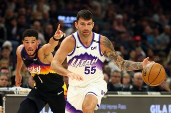 Mar 28, 2026; Phoenix, Arizona, USA; Utah Jazz guard John Konchar (55) moves the ball against Phoenix Suns guard Devin Booker (1) in the first half at Mortgage Matchup Center. Mandatory Credit: Mark J. Rebilas-Imagn Images