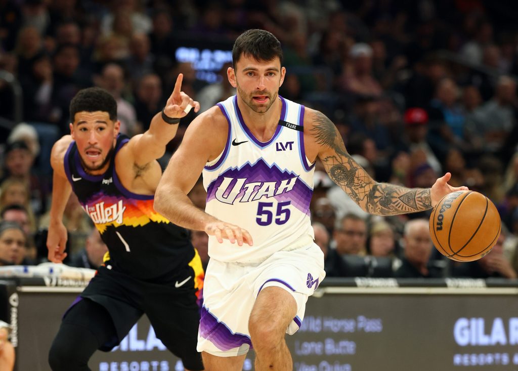 Mar 28, 2026; Phoenix, Arizona, USA; Utah Jazz guard John Konchar (55) moves the ball against Phoenix Suns guard Devin Booker (1) in the first half at Mortgage Matchup Center. Mandatory Credit: Mark J. Rebilas-Imagn Images