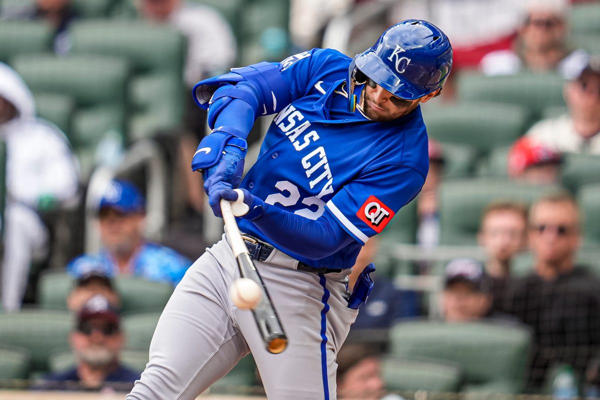 Mar 29, 2026; Cumberland, Georgia, USA; Kansas City Royals catcher Carter Jensen (22) drives in a run with a sacrifice fly against the Atlanta Braves during the eighth inning at Truist Park. Mandatory Credit: Dale Zanine-Imagn Images