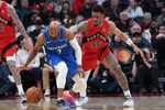 Mar 29, 2026; Toronto, Ontario, CAN; Orlando Magic guard Jevon Carter (2) controls the ball as Toronto Raptors guard Alijah Martin (55) tries to defend during the third quarter at Scotiabank Arena. Mandatory Credit: Nick Turchiaro-Imagn Images