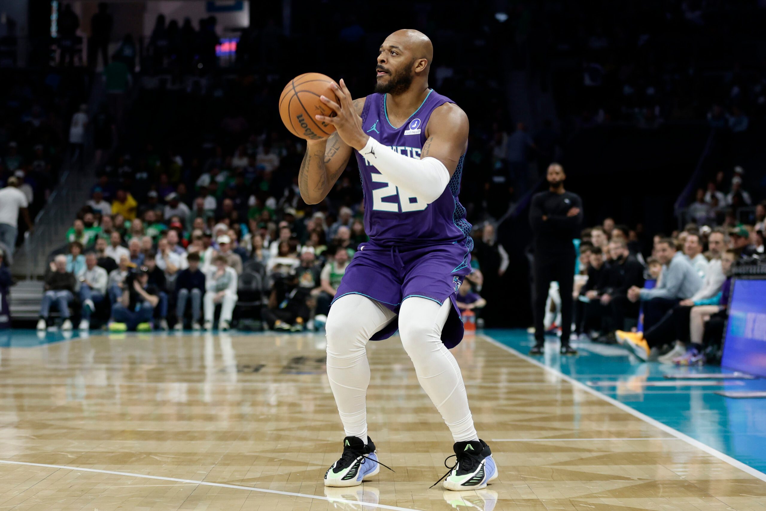 Mar 29, 2026; Charlotte, North Carolina, USA; Charlotte Hornets forward Xavier Tillman (26) prepares to attempt a three-point shot during the second half against the Boston Celtics7 at Spectrum Center. Mandatory Credit: Brian Westerholt-Imagn Images