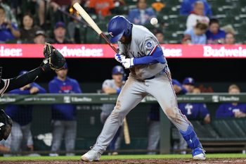 Mar 30, 2026; Baltimore, Maryland, USA; Texas Rangers first baseman Jake Burger (21) gets hit by a pitch during the fourth inning against the Baltimore Orioles at Oriole Park at Camden Yards. Mandatory Credit: Daniel Kucin Jr.-Imagn Images