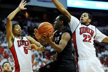 Mar 5, 2014; Las Vegas, NV, USA; San Diego State Aztecs guard Xavier Thames (2) attempts to shoot through the defense of UNLV Runnin' Rebels forward Christian Wood (5) and guard Jelan Kendrick (22) during an NCAA men's basketball game at Thomas and Mack Center. The Aztecs won the game 73-64. Mandatory Credit: Stephen R. Sylvanie-Imagn Images