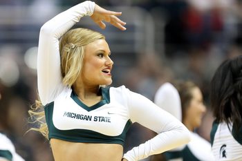 Mar 6, 2014; East Lansing, MI, USA; Michigan State Spartans cheerleader performs during the 2nd half of a game at Jack Breslin Student Events Center. MSU won 86-76. Mandatory Credit: Mike Carter-Imagn Images