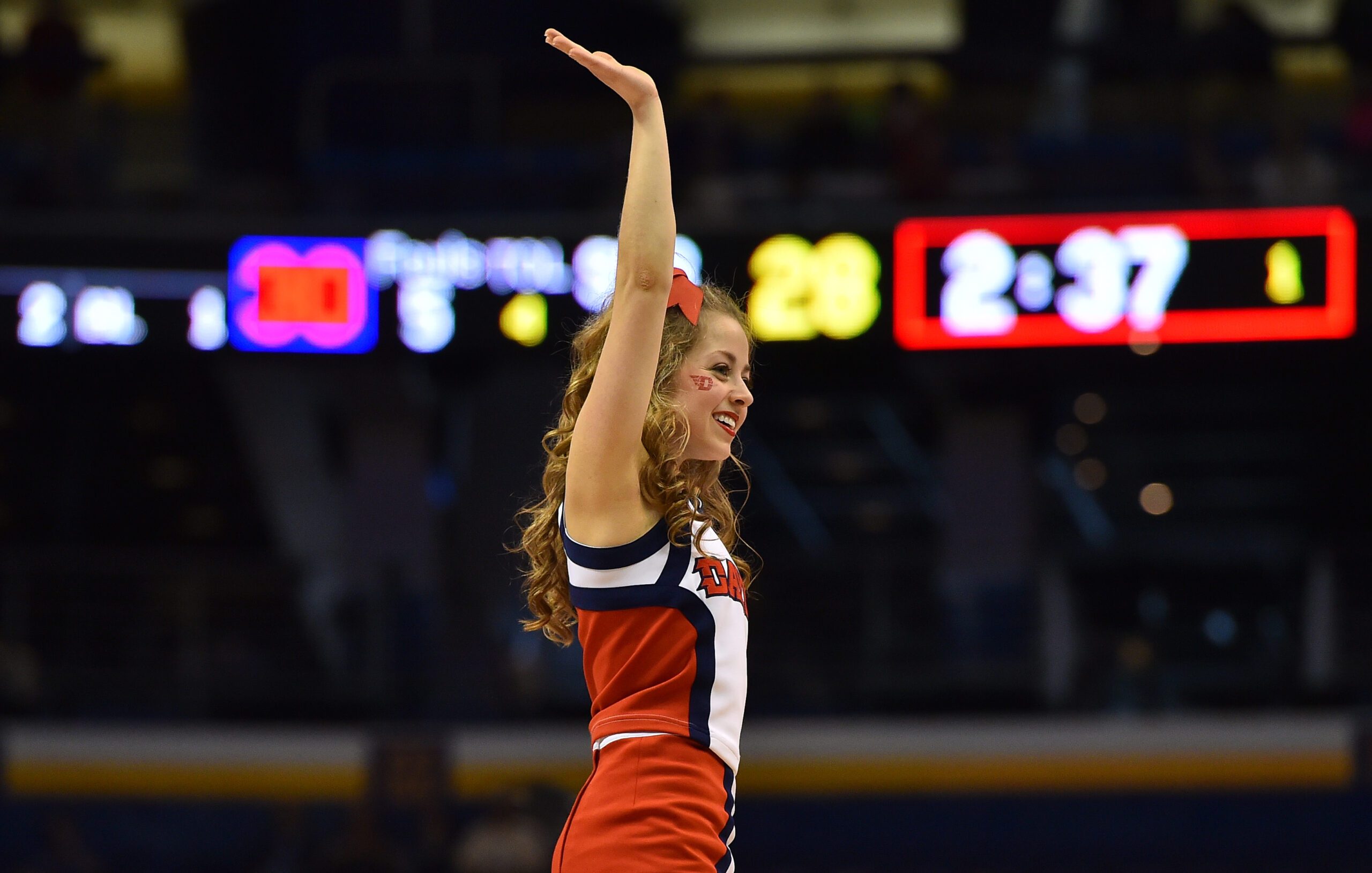 Mar 18, 2016; St. Louis, MO, USA; Dayton Flyers cheerleader waves during the first half of the first round against the Syracuse Orange in the 2016 NCAA Tournament at Scottrade Center. Mandatory Credit: Jasen Vinlove-Imagn Images