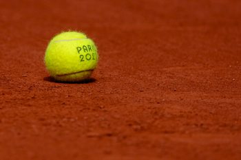 Jul 31, 2024; Paris, France; A tennis ball sits on the clay courts during the Paris 2024 Olympic Summer Games at Stade Roland Garros. Mandatory Credit: Kirby Lee-Imagn Images