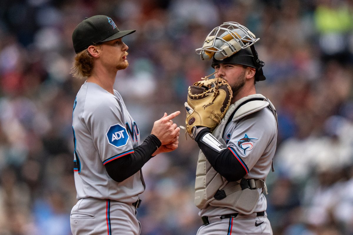 Apr 27, 2025; Seattle, Washington, USA; Miami Marlins starting pitcher Max Meyer (23), left, and catcher Liam Hicks (34) meet at the mound during the second inning against the Seattle Mariners at Lumen Field. Mandatory Credit: Stephen Brashear-Imagn Images