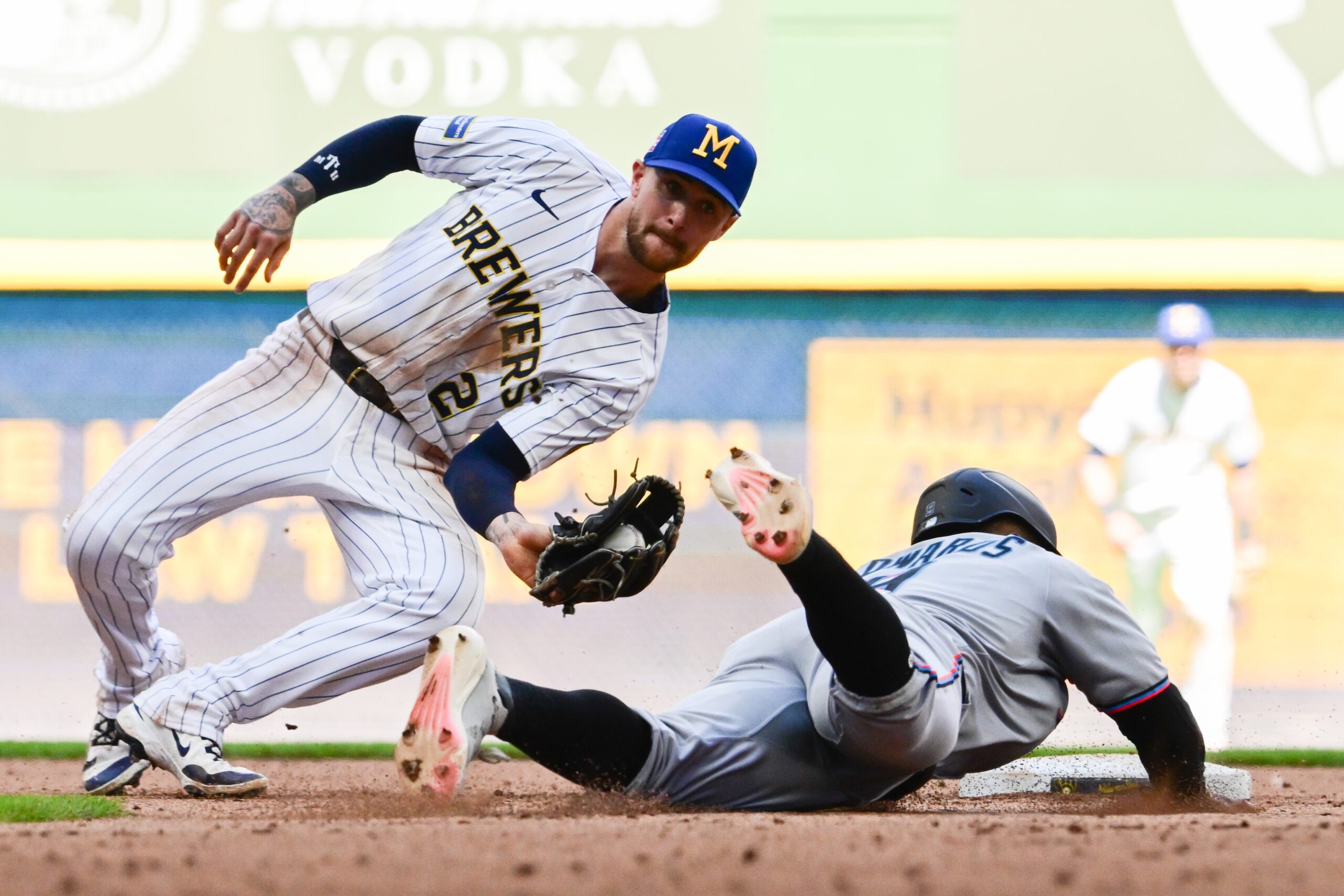 Jul 27, 2025; Milwaukee, Wisconsin, USA; Milwaukee Brewers second baseman Brice Turang (2) tags out Miami Marlins second baseman Xavier Edwards (9) trying to steal second in the seventh inning at American Family Field. Mandatory Credit: Benny Sieu-Imagn Images