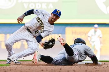 Jul 27, 2025; Milwaukee, Wisconsin, USA; Milwaukee Brewers second baseman Brice Turang (2) tags out Miami Marlins second baseman Xavier Edwards (9) trying to steal second in the seventh inning at American Family Field. Mandatory Credit: Benny Sieu-Imagn Images