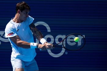 Camilo Ugo Carabelli, of Argentina, returns to Kei Nishikori, of the Japan, during the Cincinnati Open at the Lindner Family Tennis Center in Mason, Ohio, on Aug. 8, 2025.